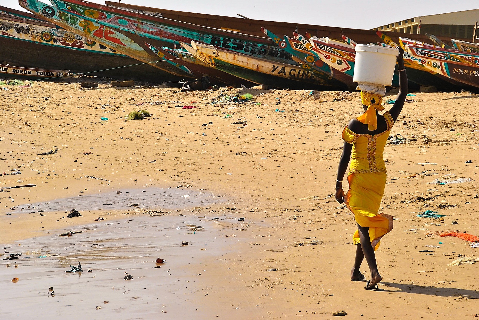 Femme avec sot sur la tête marchand sur le sable